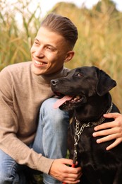 Portrait of smiling man with cute dog outdoors