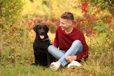 Smiling man with cute dog outdoors on autumn day