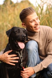 Portrait of smiling man with cute dog outdoors