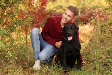 Smiling man with cute dog outdoors on autumn day