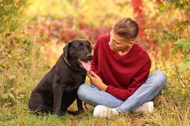 Man with cute dog outdoors on autumn day