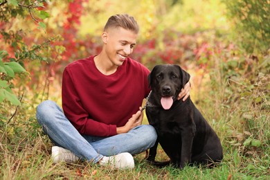 Smiling man with cute dog outdoors on autumn day