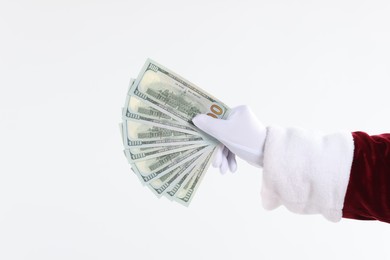 Photo of Santa Claus holding dollar banknotes on white background, closeup