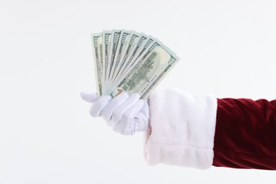 Photo of Santa Claus holding dollar banknotes on white background, closeup