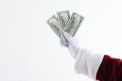 Photo of Santa Claus holding dollar banknotes on white background, closeup. Space for text