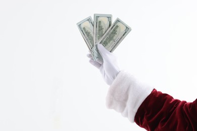 Photo of Santa Claus holding dollar banknotes on white background, closeup. Space for text