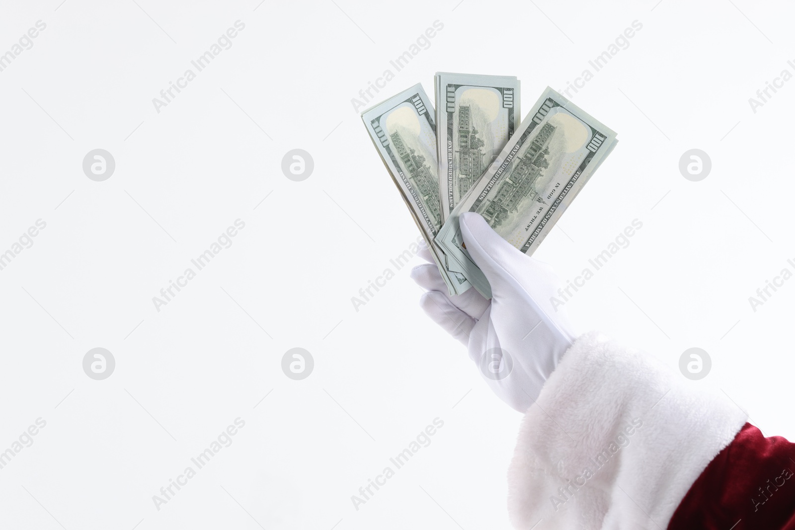 Photo of Santa Claus holding dollar banknotes on white background, closeup. Space for text