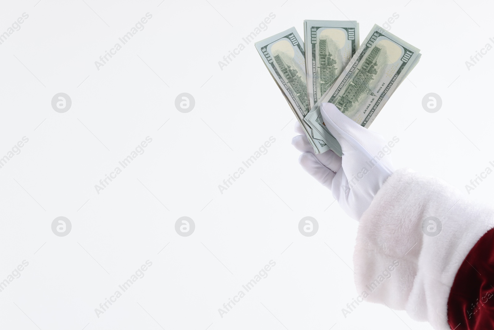 Photo of Santa Claus holding dollar banknotes on white background, closeup. Space for text