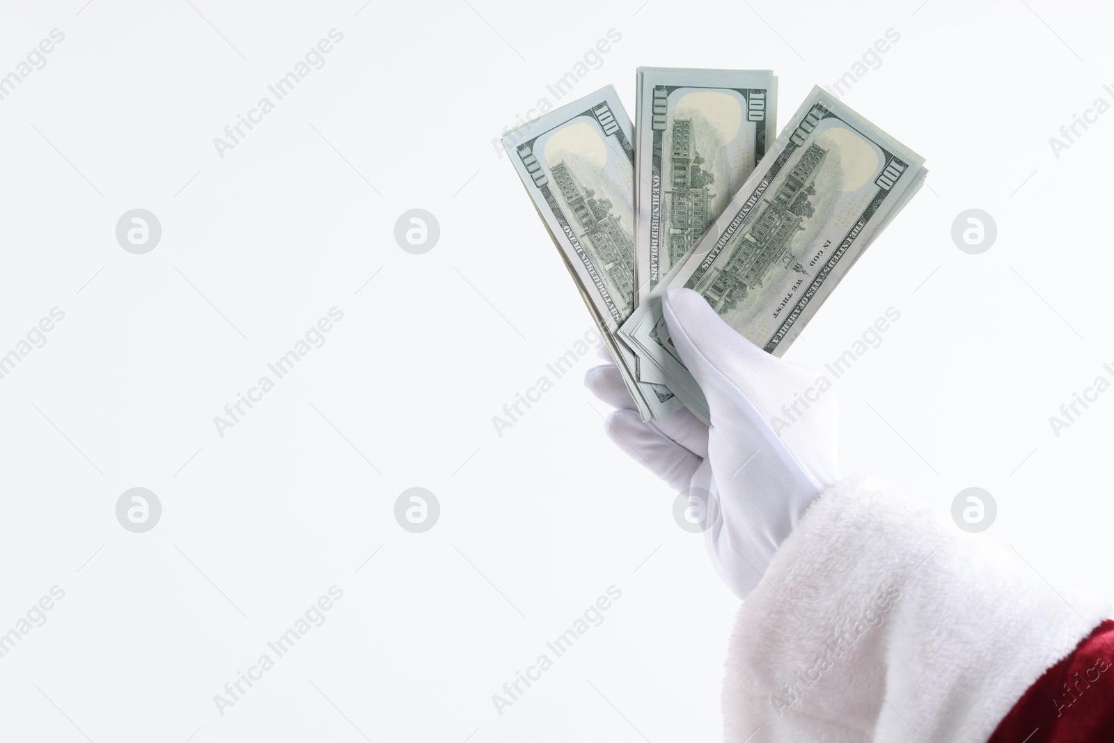 Photo of Santa Claus holding dollar banknotes on white background, closeup. Space for text