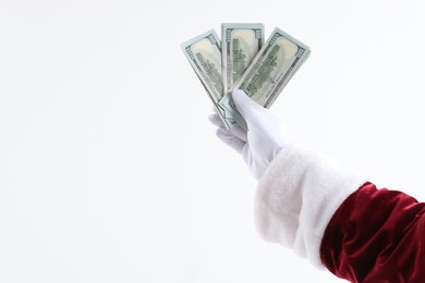 Photo of Santa Claus holding dollar banknotes on white background, closeup. Space for text