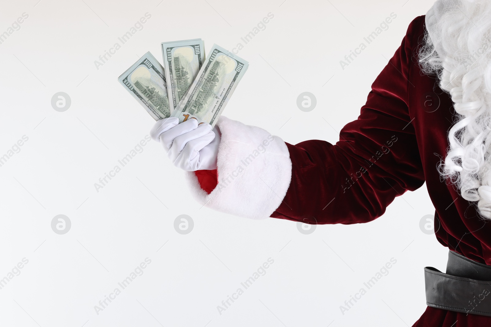 Photo of Santa Claus holding dollar banknotes on white background, closeup