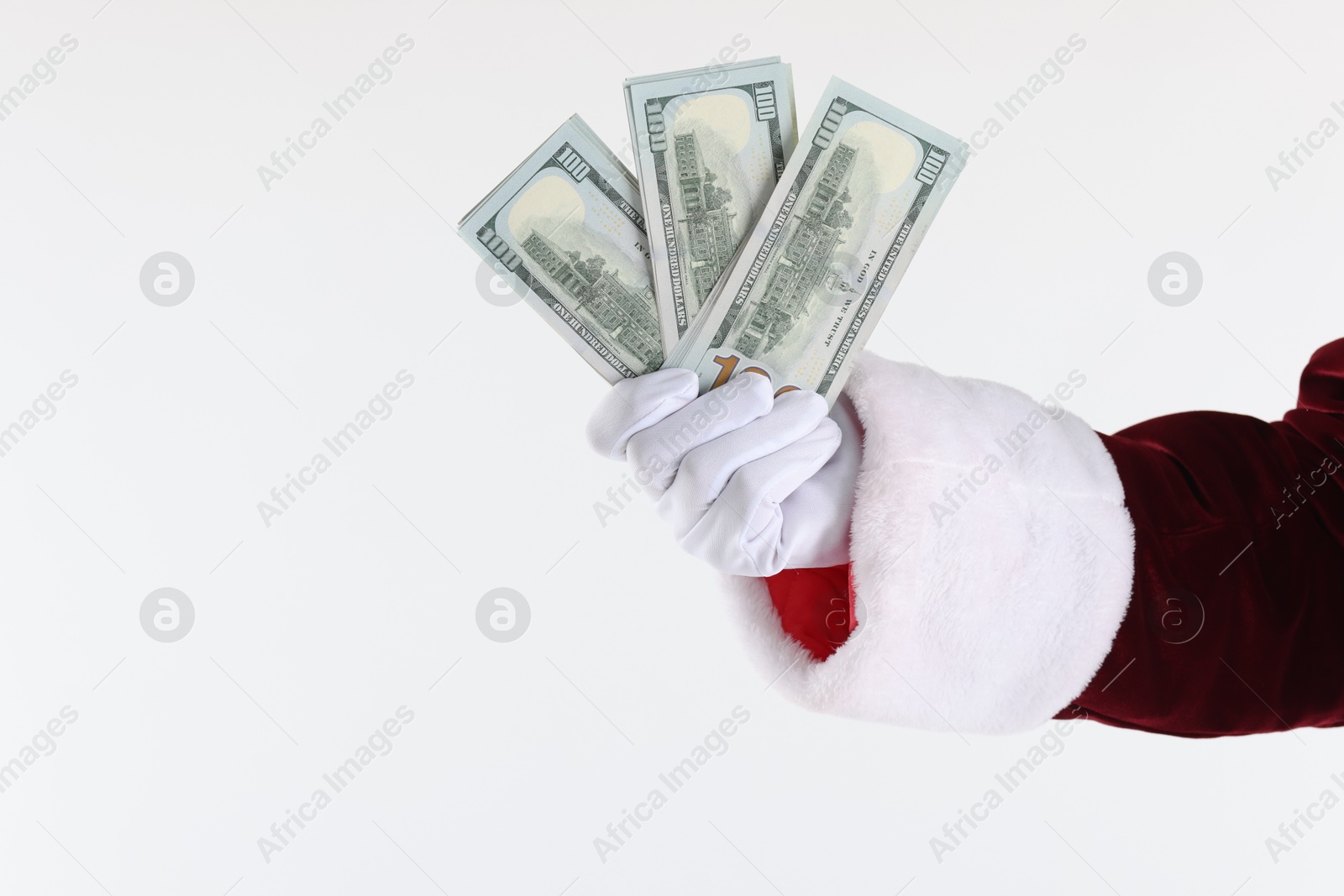 Photo of Santa Claus holding dollar banknotes on white background, closeup. Space for text