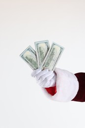 Photo of Santa Claus holding dollar banknotes on white background, closeup