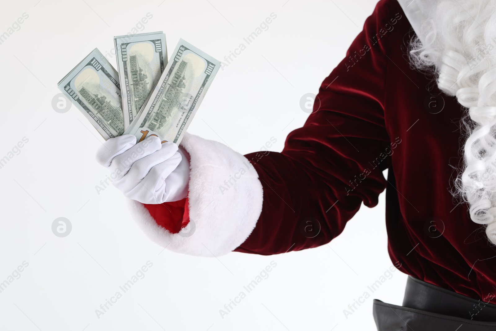 Photo of Santa Claus holding dollar banknotes on white background, closeup