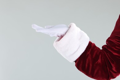 Photo of Santa Claus holding something on gray background, closeup