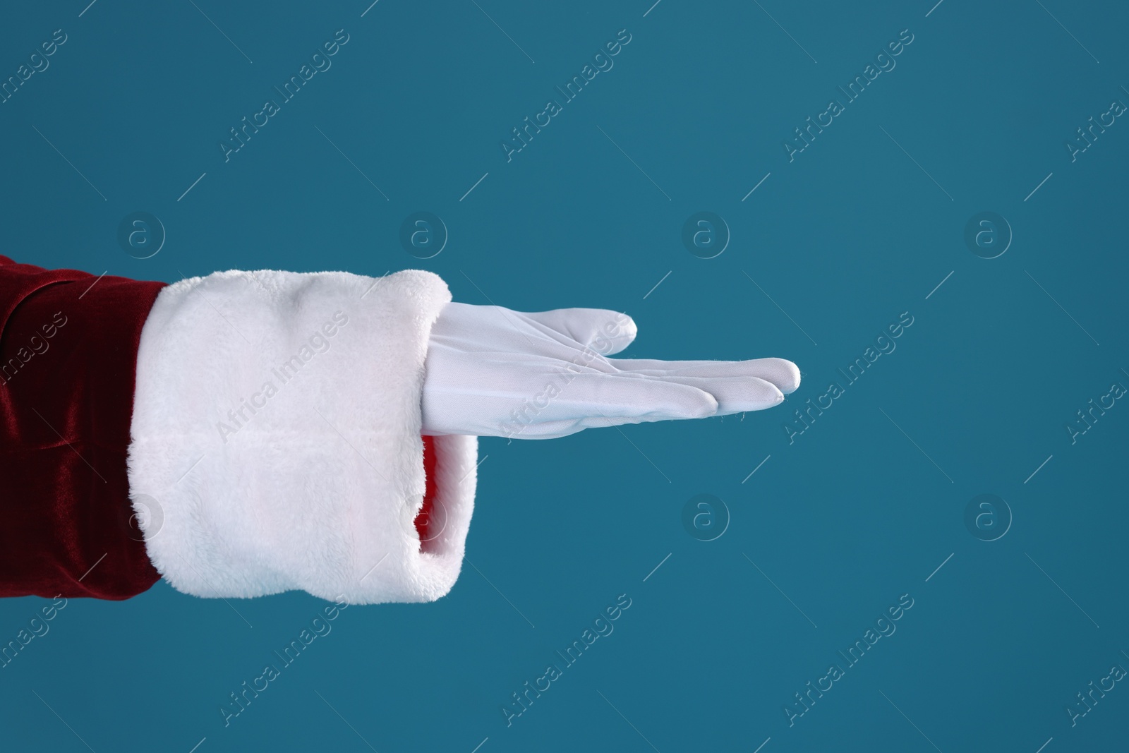 Photo of Santa Claus holding something on blue background, closeup