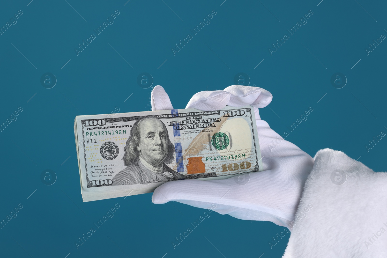 Photo of Santa Claus holding dollar banknotes on blue background, closeup