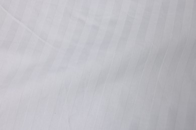 Photo of Clean white linens as background, top view