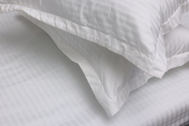 Bed with white clean linens and pillows