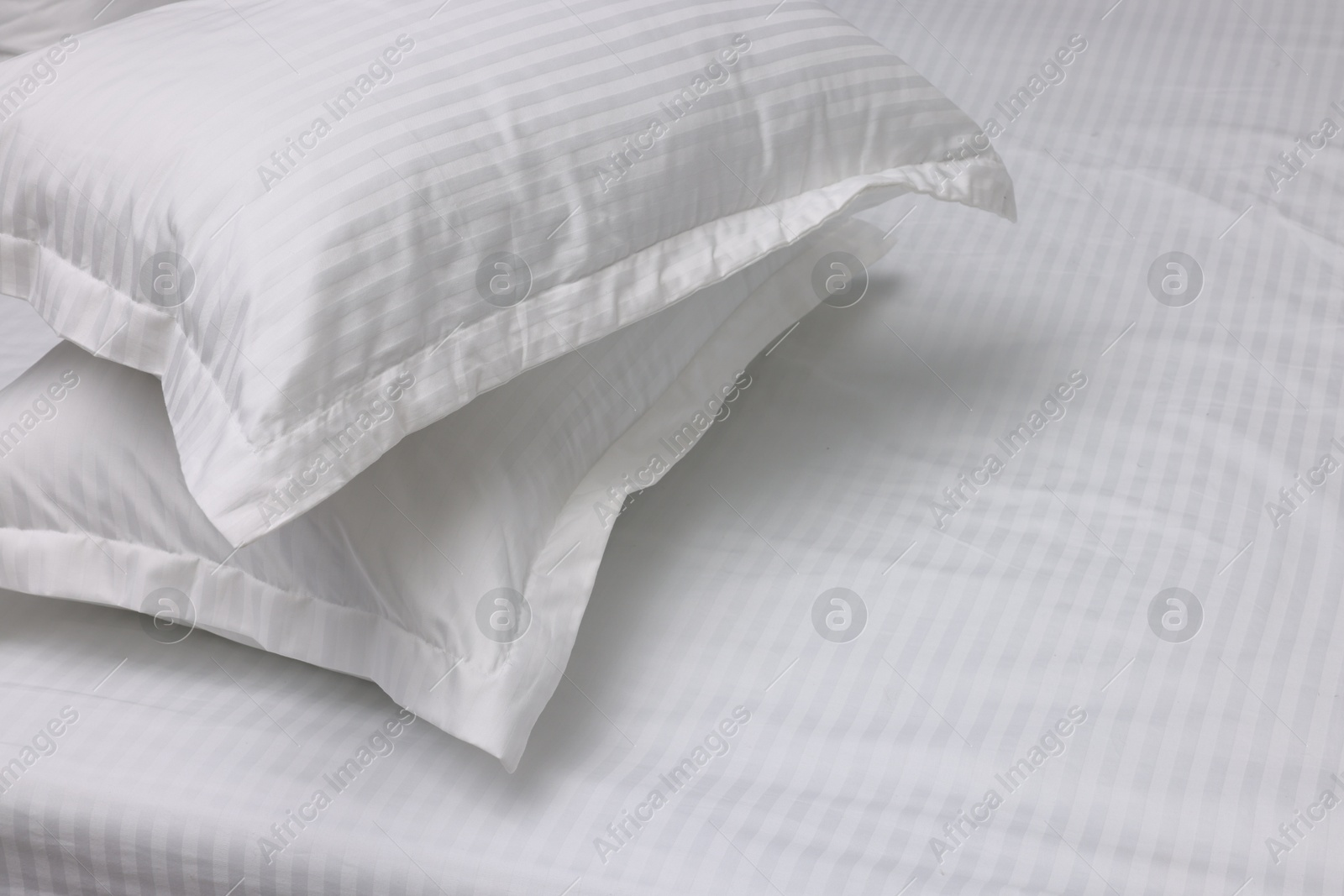 Photo of Bed with white clean linens and pillows