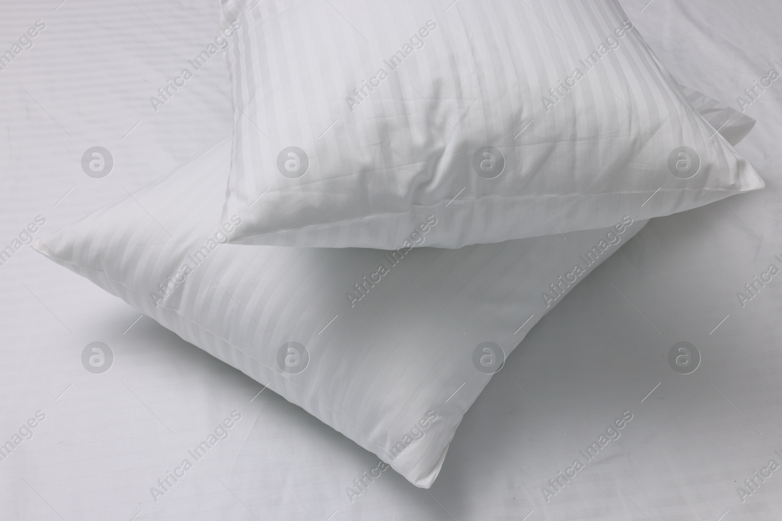 Photo of Bed with white clean linens and pillows