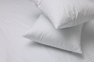 Bed with white clean linens and pillows