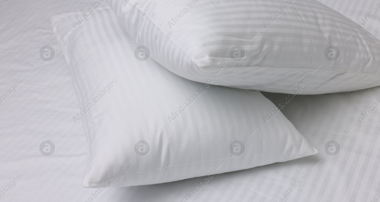 Photo of Bed with white clean linens and pillows