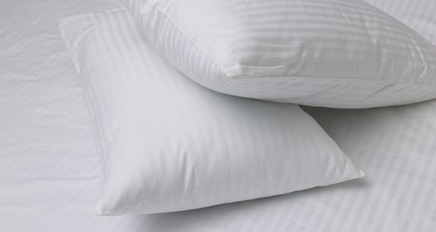 Bed with white clean linens and pillows