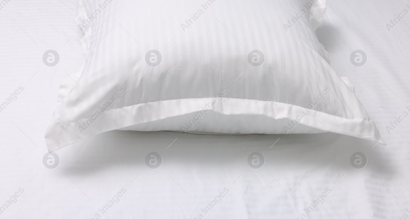 Photo of Bed with white clean linens and pillow