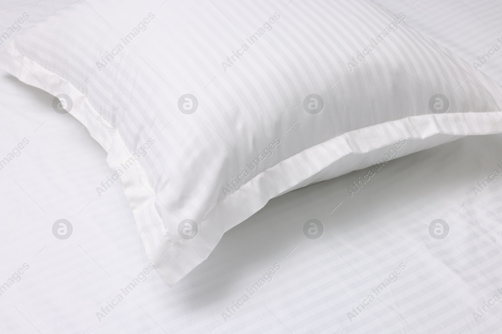 Photo of Bed with white clean linens and pillow