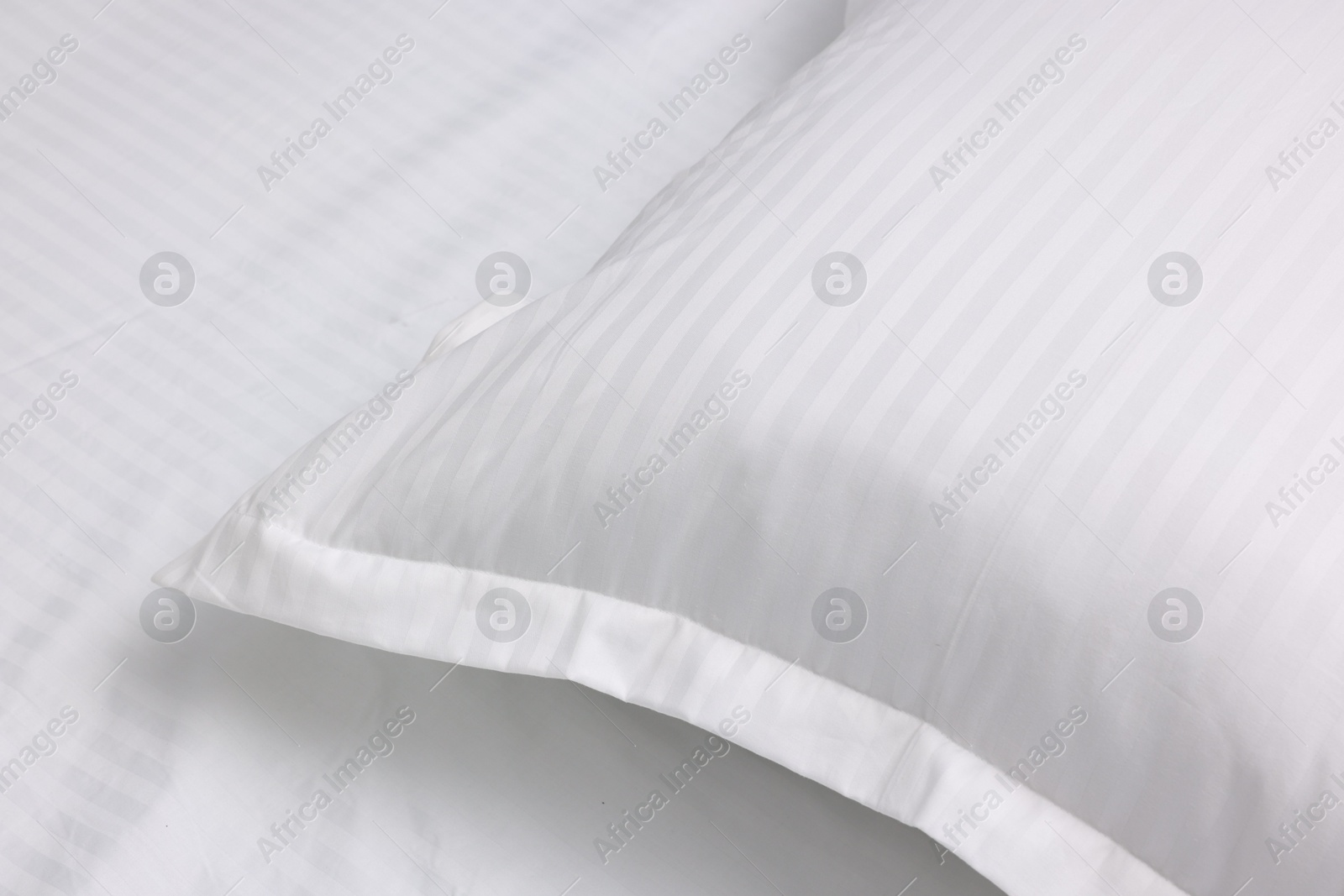 Photo of Bed with white clean linens and pillow, closeup