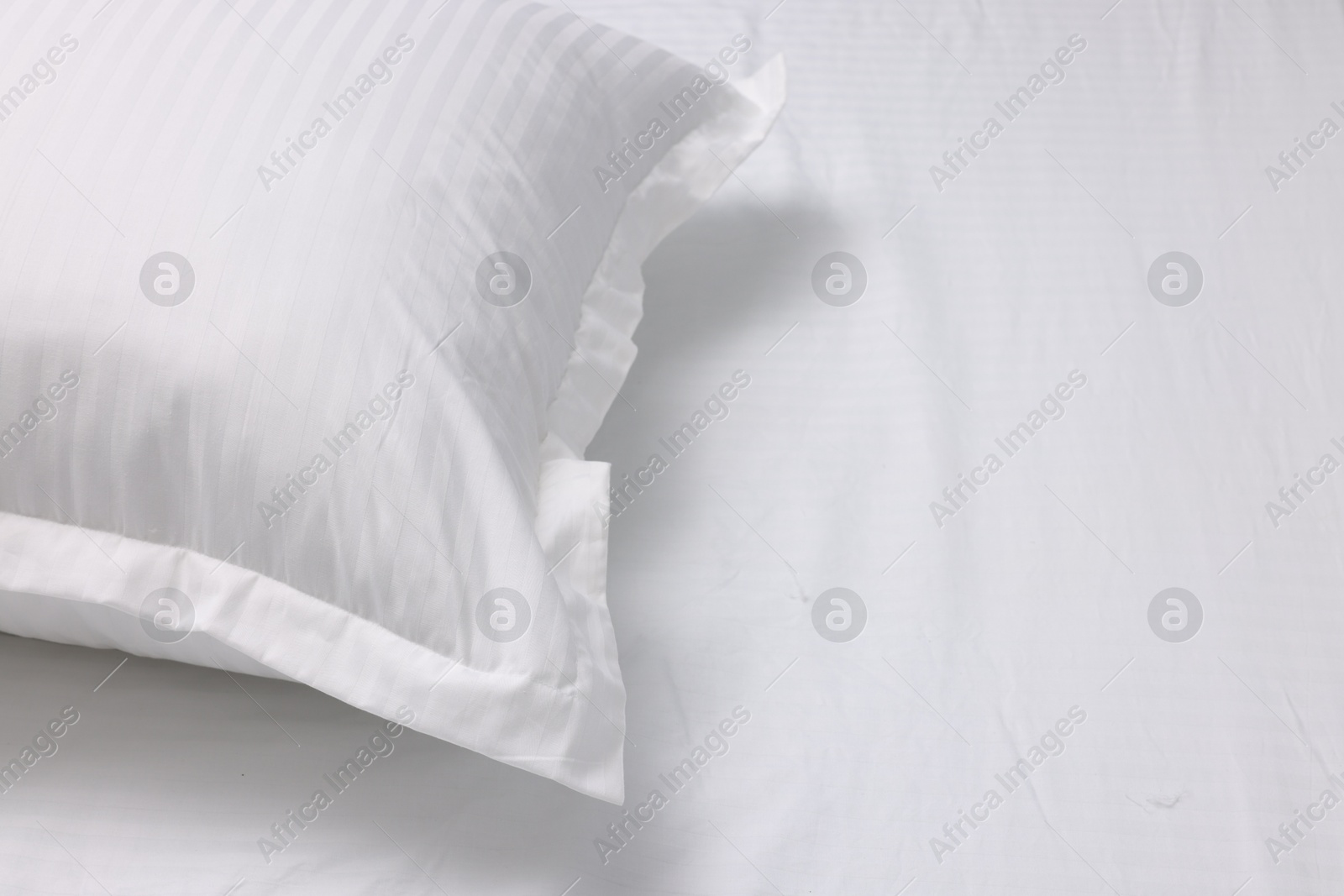 Photo of Bed with white clean linens and pillow, space for text