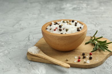 Photo of Sea salt and spices in bowl on gray textured table