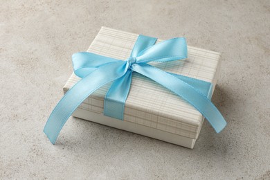 Photo of Beautiful gift box with bow on light grey table