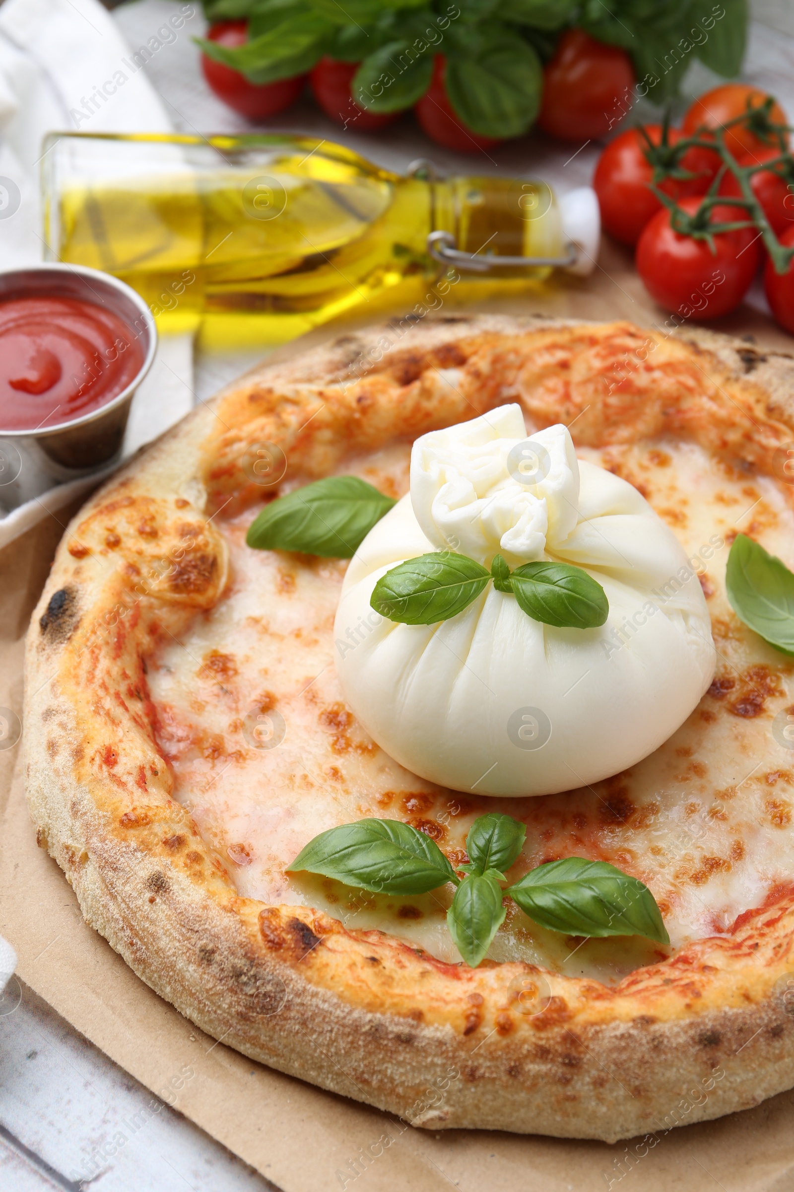 Photo of Delicious pizza with burrata cheese served on table, closeup