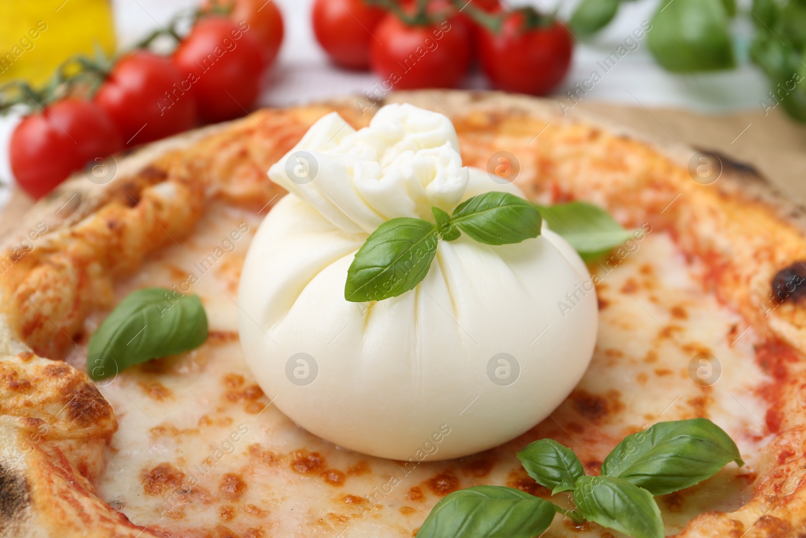 Photo of Delicious pizza with burrata cheese and basil on table, closeup