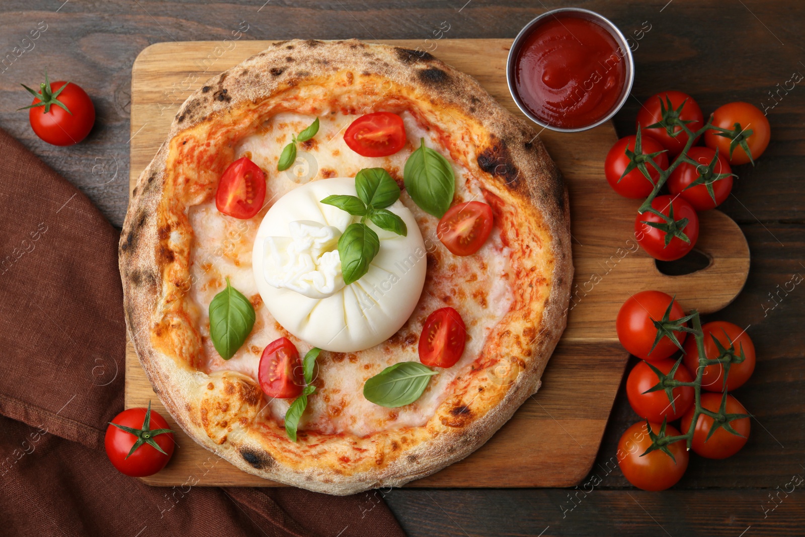 Photo of Delicious pizza with burrata cheese, basil, sauce and tomatoes on wooden table, top view