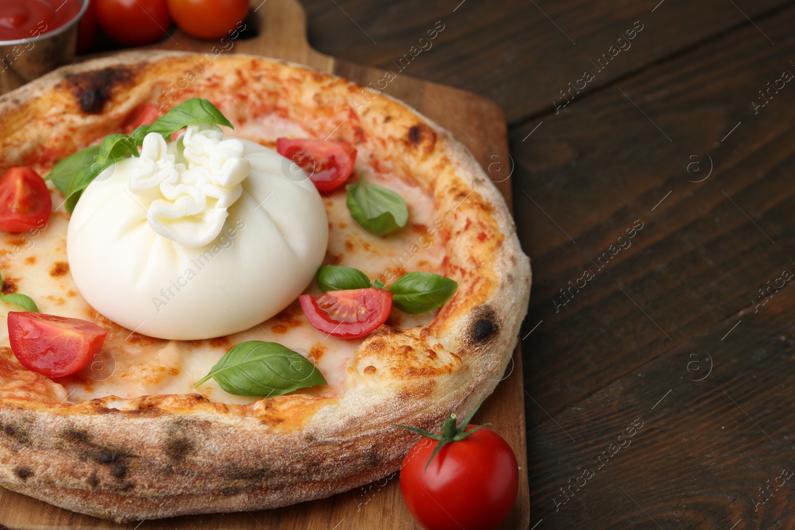 Photo of Delicious pizza with burrata cheese, basil and tomatoes on wooden table, closeup