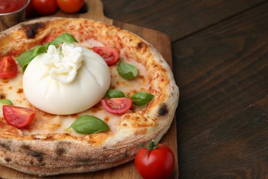 Photo of Delicious pizza with burrata cheese, basil and tomatoes on wooden table, closeup