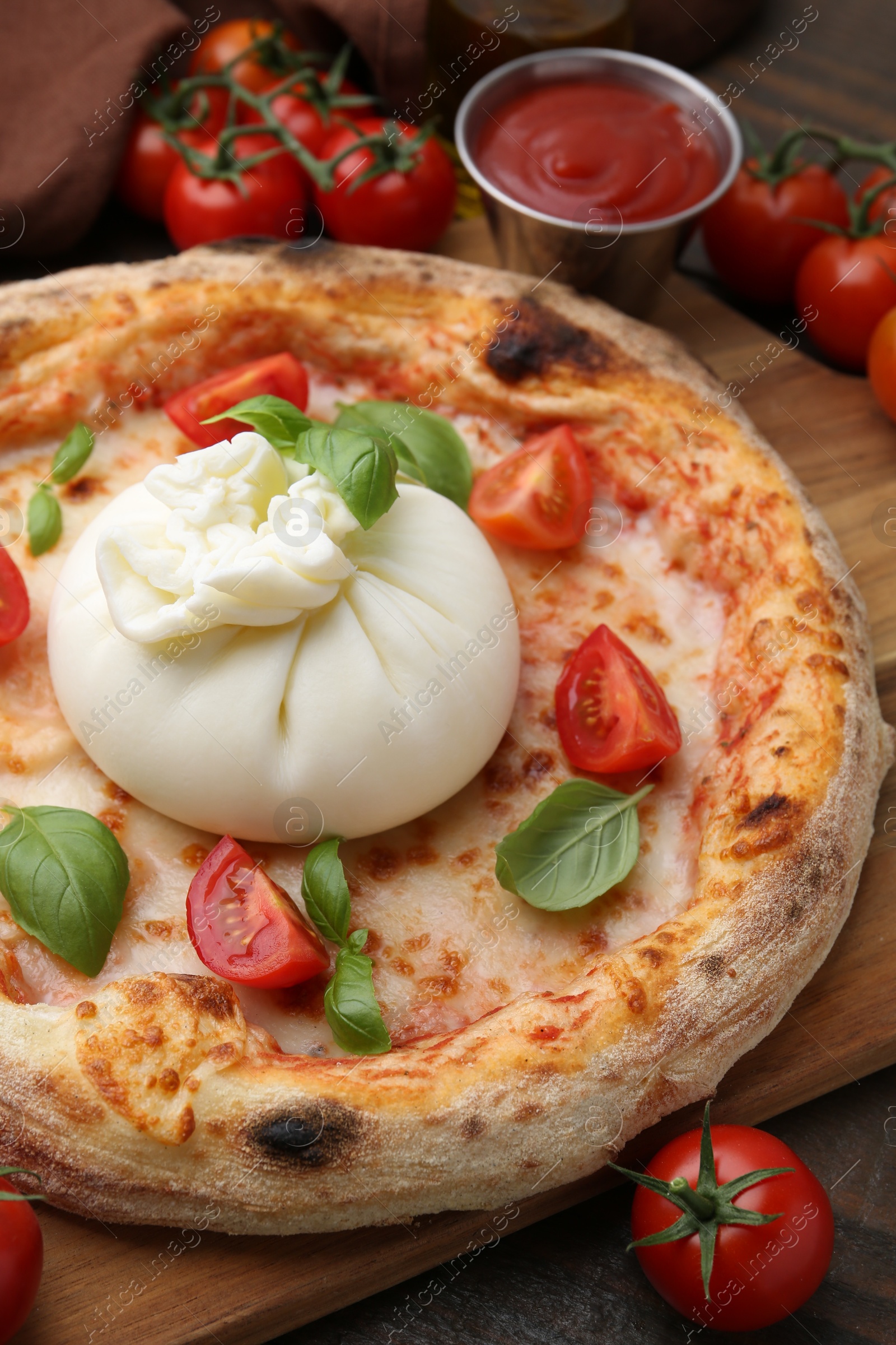 Photo of Delicious pizza with burrata cheese, basil, sauce and tomatoes on table, closeup