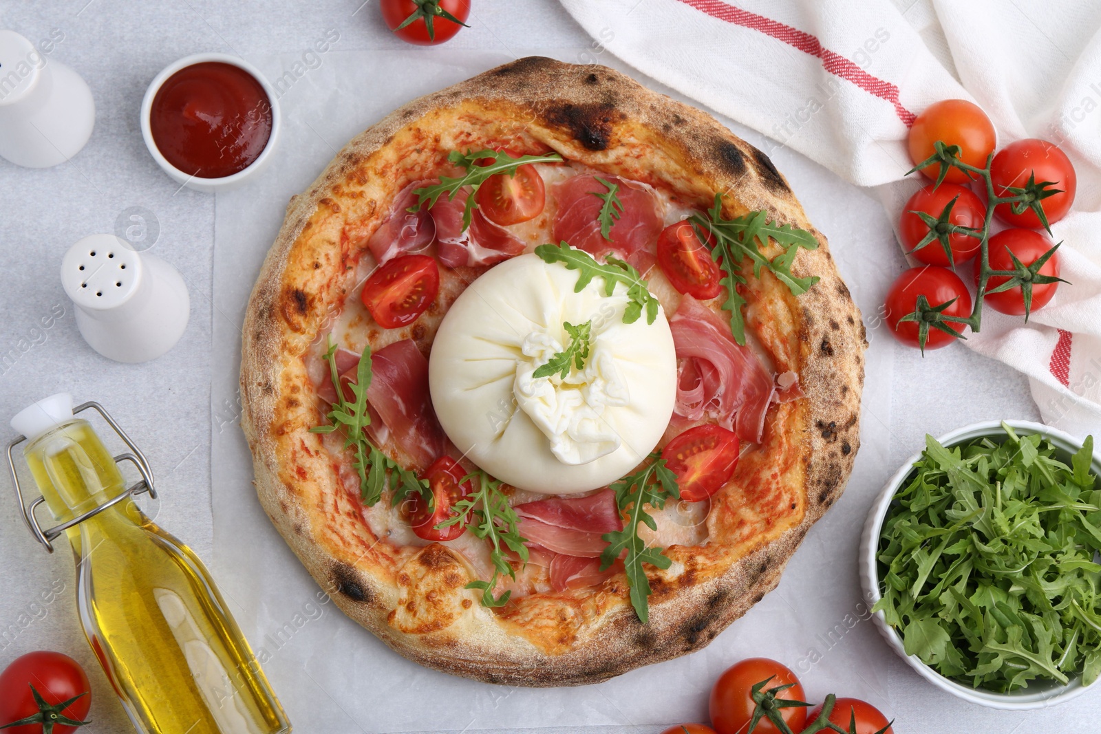 Photo of Delicious pizza with burrata cheese served on light grey table, top view