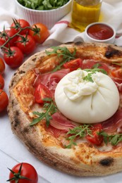 Photo of Delicious pizza with burrata cheese served on table, closeup