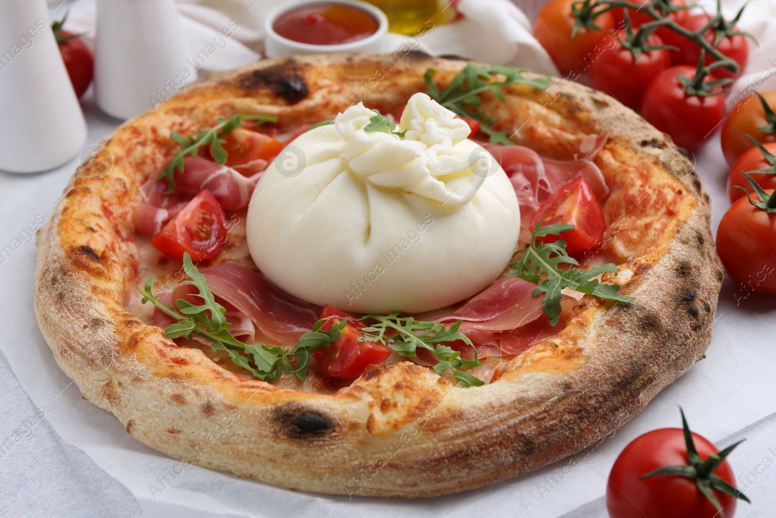 Photo of Delicious pizza with burrata cheese served on table, closeup