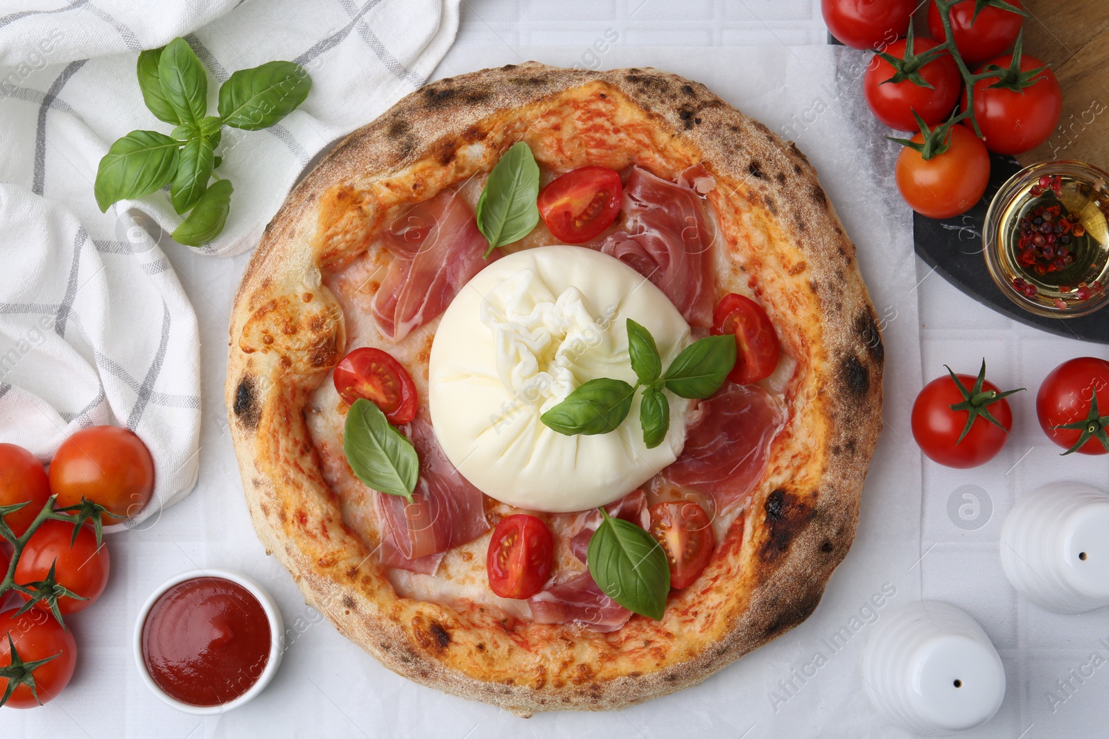 Photo of Delicious pizza with burrata cheese served on white tiled table, top view