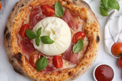 Photo of Delicious pizza with burrata cheese served on white table, top view