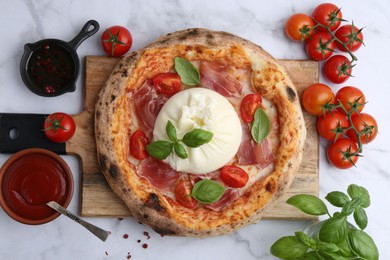 Photo of Delicious pizza with burrata cheese on white marble table, top view