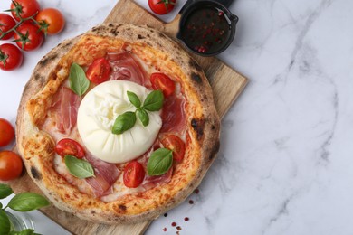 Photo of Delicious pizza with burrata cheese on white marble table, top view. Space for text