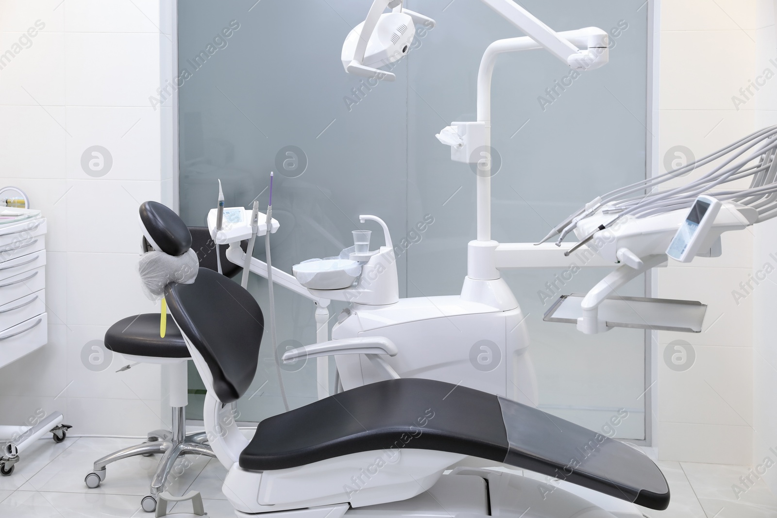 Photo of Dentist's office interior with chair and modern equipment