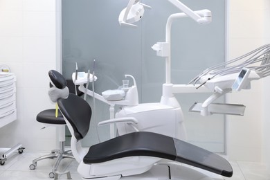 Photo of Dentist's office interior with chair and modern equipment