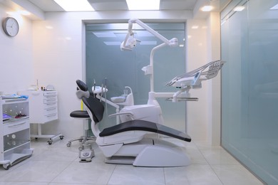 Photo of Dentist's office interior with chair and modern equipment